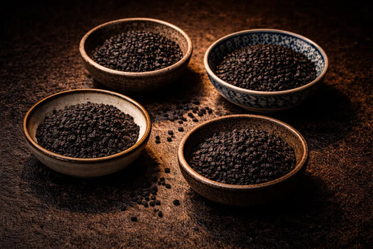 Four bowls of Nigella sativa seeds, also known as black seed, black cumin and kalonji