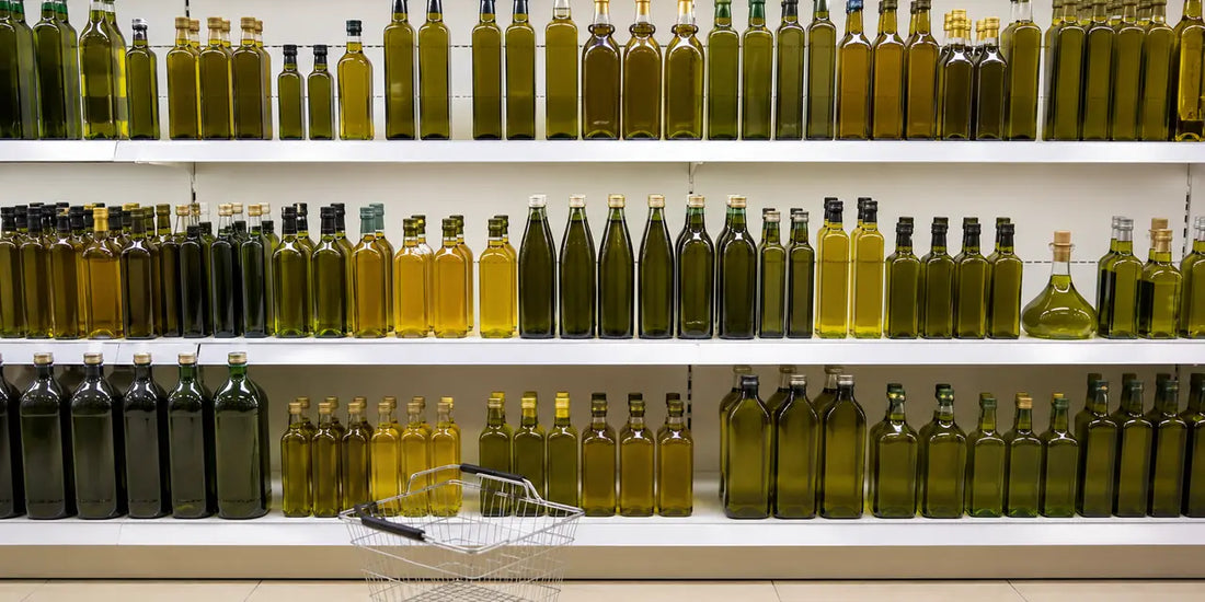 Long row of unbranded olive oil bottles on a bright supermarket shelf with a wire basket below